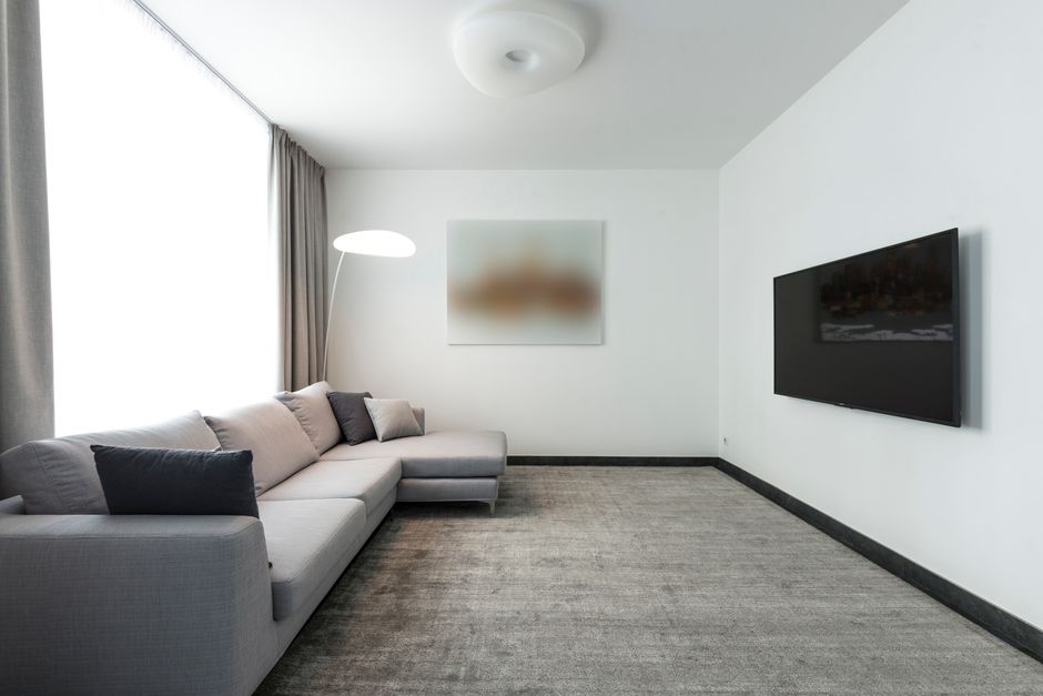 A beautifully clean and bright living room featuring a pristine carpet